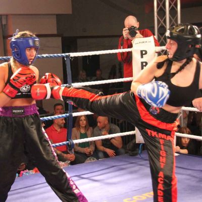 Amy Oglesbee fires a Back Kick to Rachael Mccarran at the International kickboxing event at the stormont Hotel