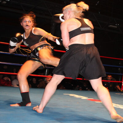  Luca Cuccu Vincis lands a low kick to Cathy McAleer