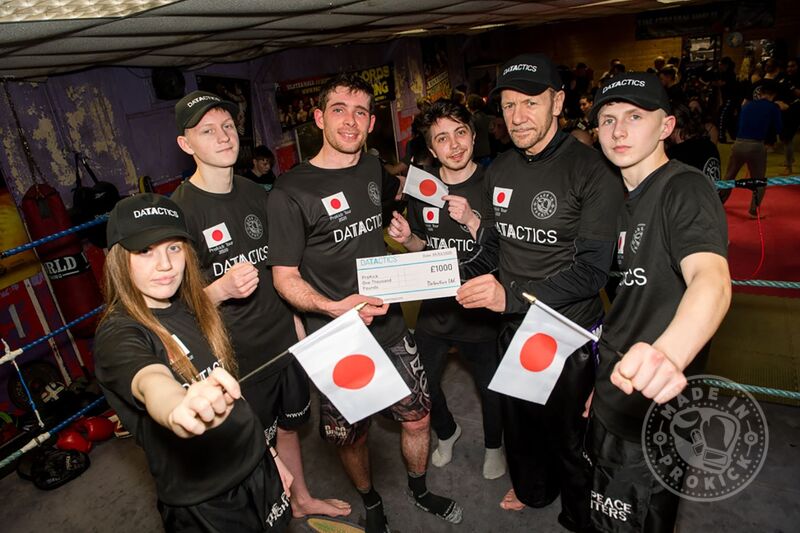 Jordon Gill from Marketing & Jordan Wray a Business Development Executive at Datactics presented the Japan team with a cheque for £1000 with ProKick members watching on.