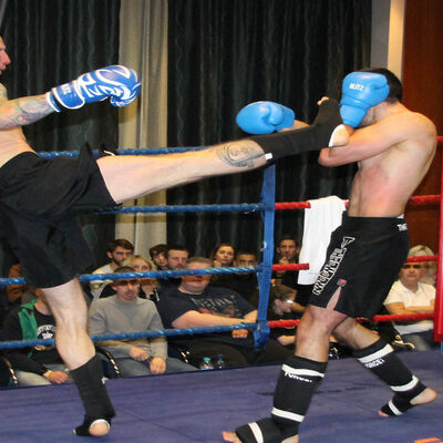 Darren McMullan throws a high kick to Nikos Kollias (Cyprus)