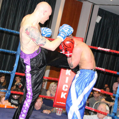 Matthew Kerr lands a round kick the Shane Weir (Fraserburgh)