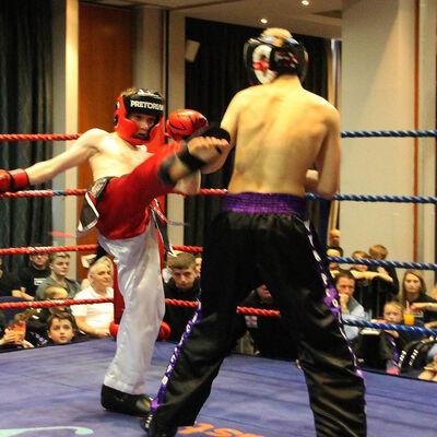 Jack Anderson shoots a good round kick to James Braniff at the Clayton hotel fight day