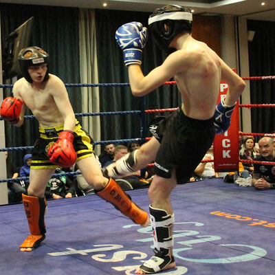 Joshua Madden (Belfast, NI) lands a low-kick to Liam Green (WestBank Kickboxing Club, Derry)