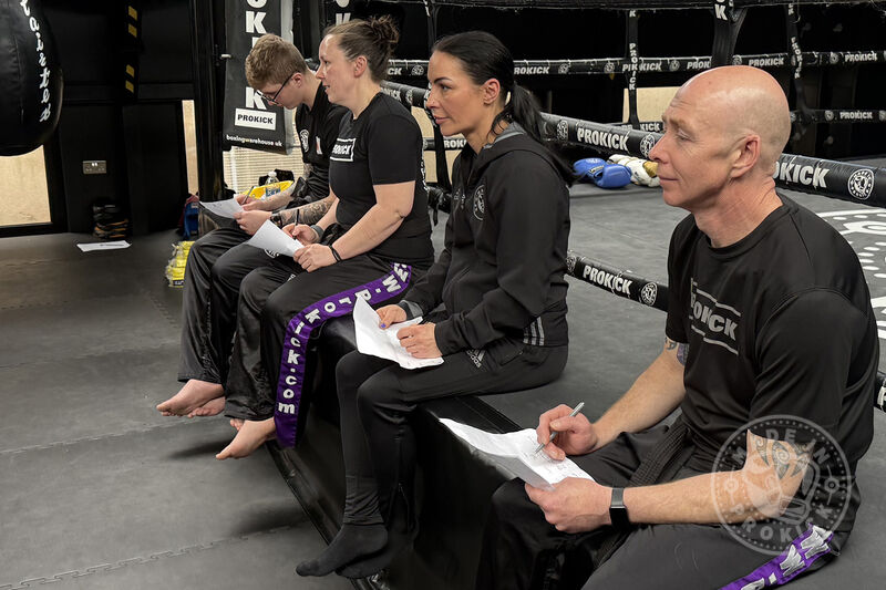 Four ProKick Black Belts—Jay Snoddon, Ruth Anderson, Rowen Bolt, and Mark Cairnduff—assisted senior coach Billy Murray with a recent grading. They helped guide students and maintain ProKick's high standards.