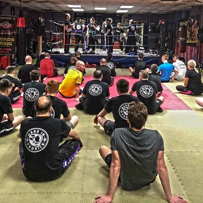 Ring Work, Seniors working through Self-defense drills in the ring whilst advanced Beginners look on.