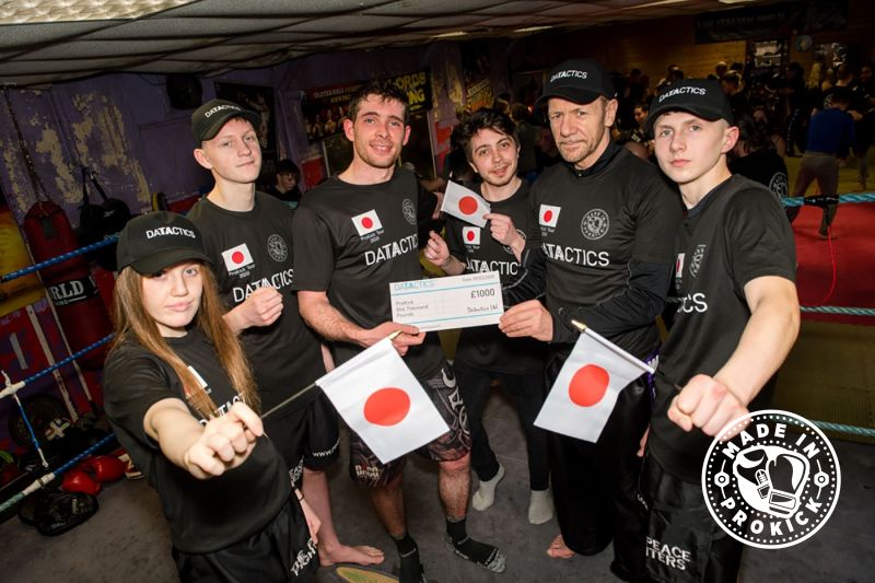 Jordon Gill from Marketing & Jordan Wray a Business Development Executive at Datactics presented the Japan team with a cheque for £1000 with ProKick members watching on.