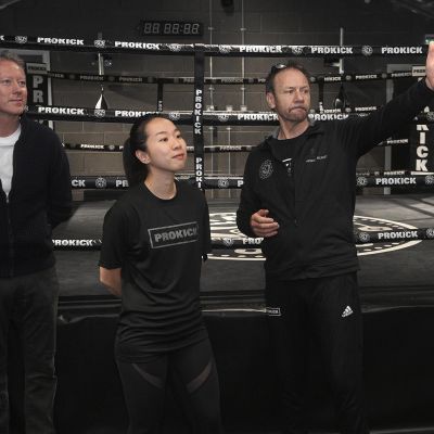 Billy Murray explains about moving the ring under the lights for competitions to Mr Mark Graham and Yuko around the iconic new ProKick gym.