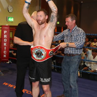 Mr Seamus Fyfe PPLK - one of the event sponsors placing the belt around the waist of Johnny Smith. The ProKick event was for the WKN title match with Jihoon Lee Vs Johnny 'Swift' Smith at the Clayton hotel Belfast on 23rd, June 2019